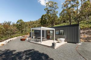 a modular house with a toilet on a gravel lot at Bracken Retreat - Hobart in Brighton
