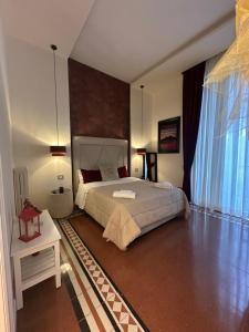 a bedroom with a large bed and a large window at Domus Capodimonte in Naples