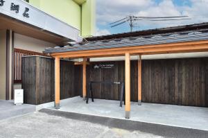 a building with a garage with wooden doors at KKR Suwakoso in Suwa +45 photos