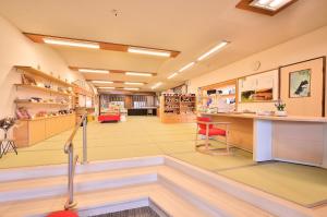a lobby of a pharmacy with a red chair at KKR Suwakoso in Suwa