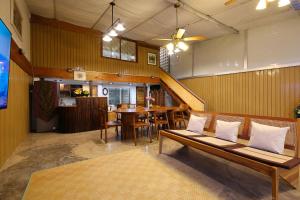 a living room with a couch and a table at Mata villa มาตา วิลล่า in Chiang Mai