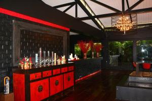 a bar with a red counter with drinks on it at 05 - Exquisite Paradise Retreat in Nai Thon Beach