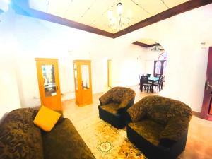a living room with two chairs and a table at OSRA HOLIDAY In in Katunayaka