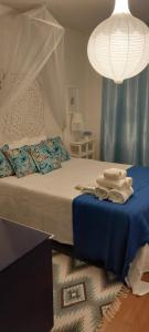 a bedroom with a bed with blue sheets and a lamp at Férias de Sonho in Arcos de Valdevez