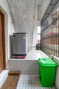 a green trash can sitting next to a balcony at Maven 1BHK Khar W by The Bombay Home Company in Mumbai