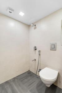 a bathroom with a toilet and a shower at Maven 1BHK Khar W by The Bombay Home Company in Mumbai