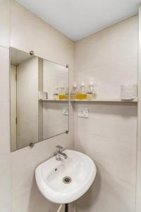 a bathroom with a sink and a mirror at Maven 1BHK Khar W by The Bombay Home Company in Mumbai +17 photos