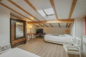 a bedroom with two beds and a skylight at El Cedro in Abejar