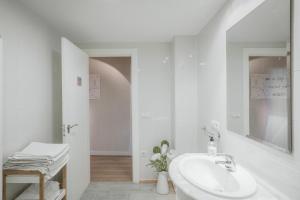 a white bathroom with a sink and a mirror at El Cedro in Abejar +19 photos