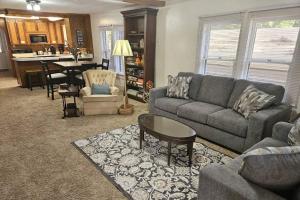 a living room with a couch and a table at Moody Woods in Orange Park +42 photos