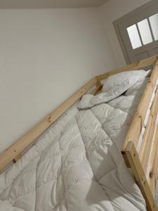 an empty bed in a room with a window at Fernando in La Chaux-de-Fonds