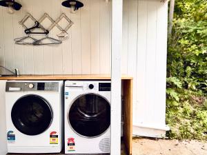 a washer and dryer sitting outside of a house at The Metta House in Mount Tamborine