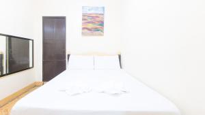 Postel nebo postele na pokoji v ubytování Golden Pegasus Hotel La Union by RedDoorz