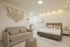 a bedroom with a bed and a couch at Elita suite in Eilat
