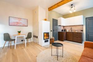 a kitchen and living room with a table and a fireplace at Studio apartment in Väike street in Viljandi