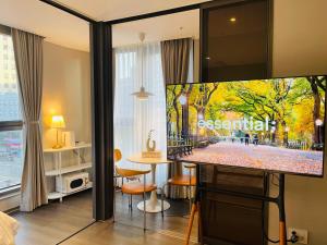 a living room with a flat screen tv in a room at Villiv Inn-the City Namsan in Seoul