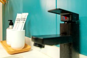 a bathroom with a mirror and a holder with toiletries at Locals Apartment House 42 in Changsha +23 photos