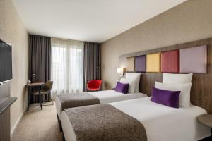 Postel nebo postele na pokoji v ubytování Mercure Budapest Korona