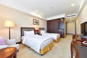 Letto o letti in una camera di Evergreen Laurel Hotel, Shanghai