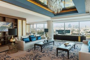 a living room with a couch and a large window at Marriott Marquis Dubai Creek in Dubai