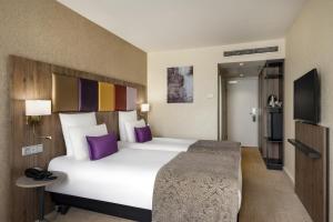 Postel nebo postele na pokoji v ubytování Mercure Budapest Korona
