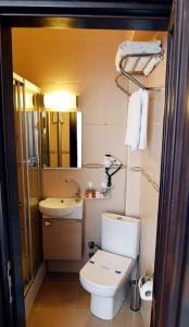 a small bathroom with a toilet and a sink at Büyükada Marine House Hotel in Istanbul +17 photos