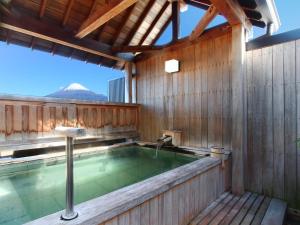 Ōmiya割烹旅館小川荘的木质建筑中的热水浴池