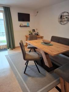 a dining room with a wooden table and chairs at Haus Kaufmann in Ellmau