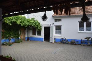a white house with a courtyard in front of it at Ubytování u vinaře in Břeclav