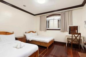 Postel nebo postele na pokoji v ubytování Villa Moa Baguio