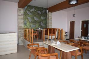 a dining room with a table and chairs at Treecasa Resort in Sunāri