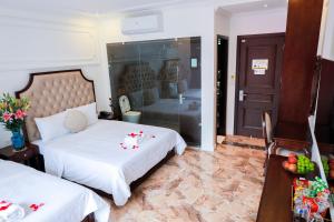 Postel nebo postele na pokoji v ubytování Royal Hotel Trâu Quỳ