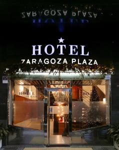 a hotel zaccoza plaza is lit up at night at Hotel Zaragoza Plaza in Donostia-San Sebastián