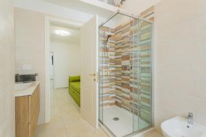 a bathroom with a shower and a sink at Ricasoli27 in Mottola