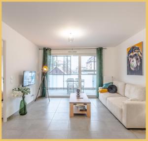 a living room with a couch and a table at Le 1848 I T2 I Cluses in Cluses