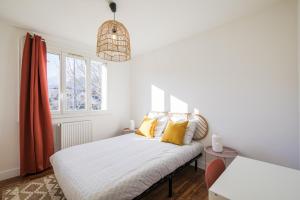 una camera da letto con letto e cuscini gialli di Le Vercors - 6 couchages parking gratuit a Fontaine