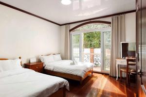 Postel nebo postele na pokoji v ubytování Villa Moa Baguio