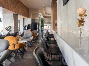 a bar with chairs and tables in a restaurant at Rise Urban Art Hotel in Larnaca