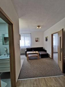 a living room with a couch and a table at Apartmány Star in Kežmarok