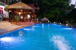 a swimming pool at night with a gazebo at Mai Châu Lotus in Mai Châu