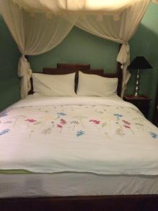 a bed with a white bedspread and pillows at Daly View Bed & Breakfast in Fremantle