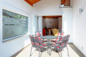 a dining room with a table and chairs at Ferienhaus MöwenNest mit Garten und Kamin in Silz