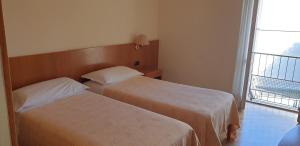 Postel nebo postele na pokoji v ubytování Hotel Tre Re