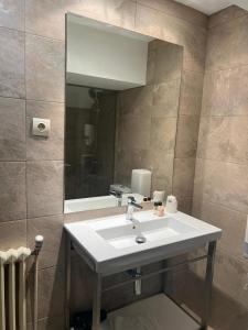 a bathroom with a sink and a mirror at Hotel Port 1730 in La Coma i la Pedra +94 photos