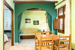 a living room with a table and a couch at Allotjaments Plaça Major-Aulina in Santa Pau