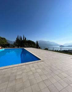 a swimming pool with a view of the water at NEW Luxury Apartment - Menaggio in Menaggio