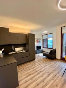 an open living room with a kitchen and a living room at NEW Luxury Apartment - Menaggio in Menaggio