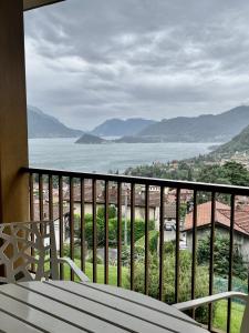 a balcony with a view of the water at NEW Luxury Apartment - Menaggio in Menaggio