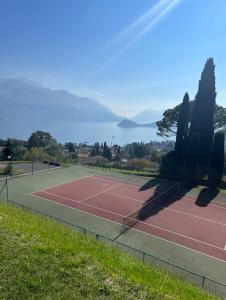 a tennis court with a view of the water at NEW Luxury Apartment - Menaggio in Menaggio +7 photos