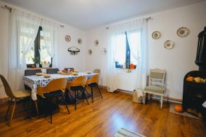 a dining room with a table and chairs at CHRISTE FOREST RETREAT Bed & Chocolate in Floreşti